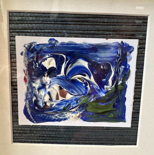 An abstract mixed-media painting featuring swirling blue, white, and black paint with green accents, mounted on grass cloth in a white box frame 27cm square 