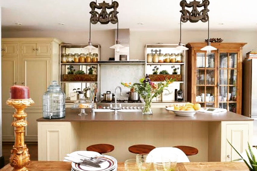 Modern kitchen with wooden island, pendant lights, and decorative elements.