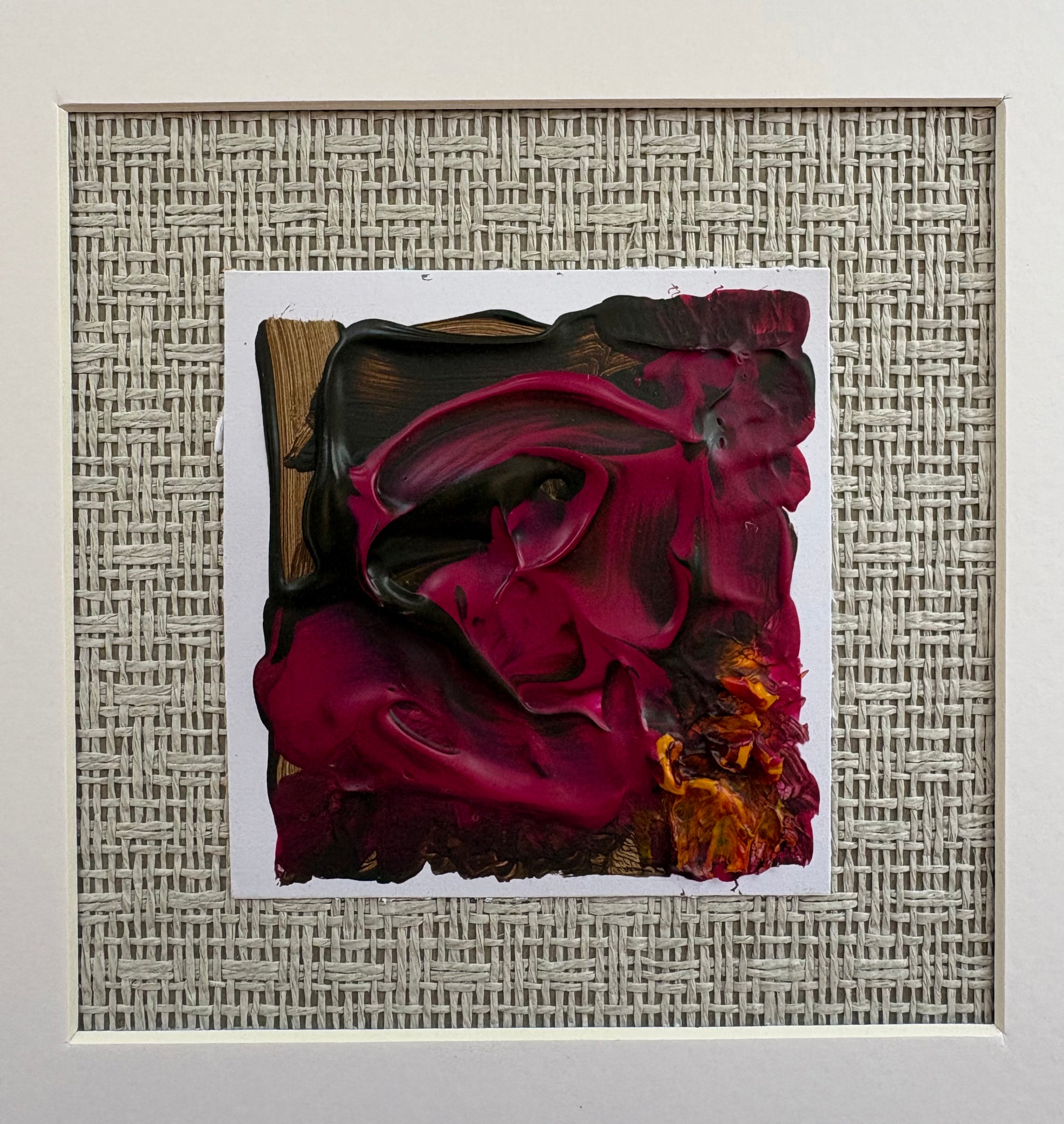 Explores the tension between depth and luminosity. Layers of rich crimson, blackberry and charcoal drift across the surface, interrupted by flashes of amber that emerge like embers beneath the paint. Mounted against a woven grass cloth backdrop, the work brings together texture, colour and materiality — a nod to Fleur Ward’s background in interiors, where surfaces and atmosphere are as important as form. The result is a piece that feels both organic and expressive, inviting the viewer to discover their own 