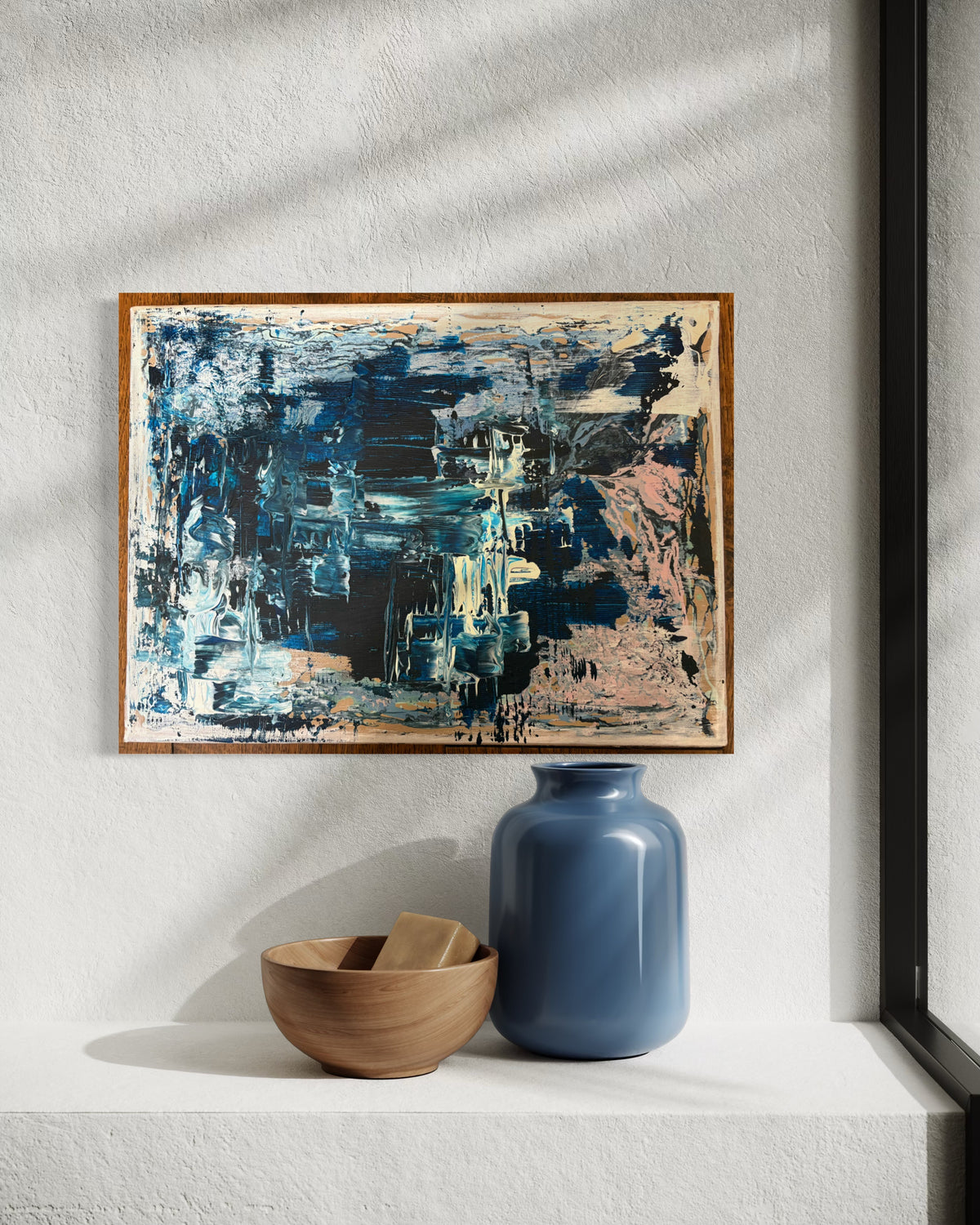 Night Tide explores the quiet moments between movement and stillness. Layers of deep indigo, charcoal and soft mineral tones drift across the canvas, revealing glimpses of light beneath heavier textures. The painting hints at reflections on dark water, weathered surfaces and fading horizons, never settling into a single place or story. Like much of Fleur Ward’s work, it invites the viewer to pause, look closer and discover their own landscape within the abstract.