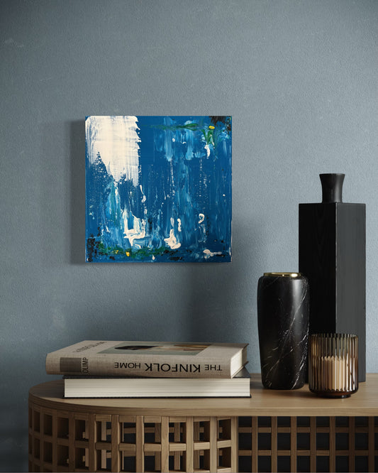 Layers of deep blue are interrupted by a sweeping white form that recalls the energy of a wave as it gathers, curls and breaks. Veils of paint, suspended drips and flashes of sea green suggest foam, tide and the restless movement of the shoreline. Rather than depicting a specific seascape, the painting captures a fleeting moment of force and release—where water reshapes everything it touches.
