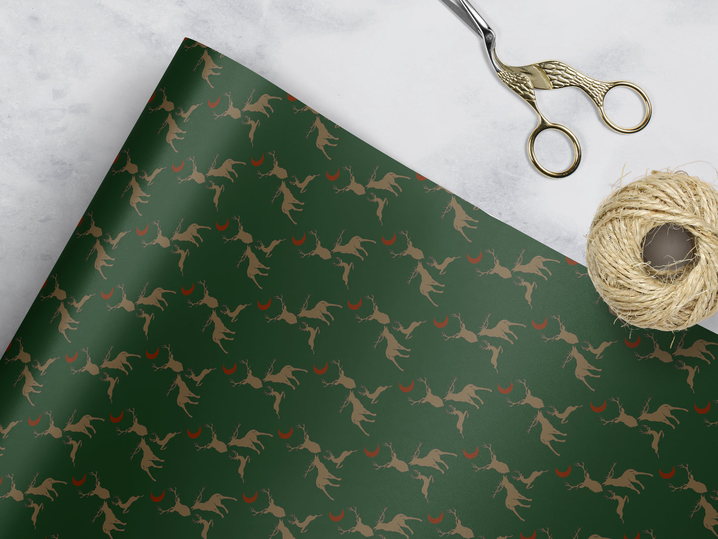 green Wrapping paper with 3 brown stags and a red moon 