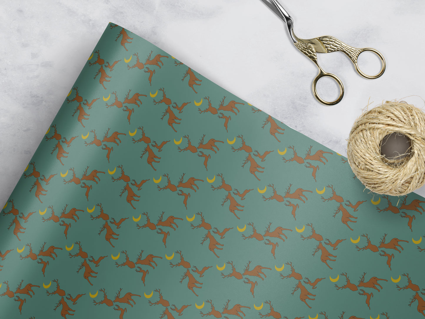green Wrapping paper with 3 brown stags and a yellow moon 