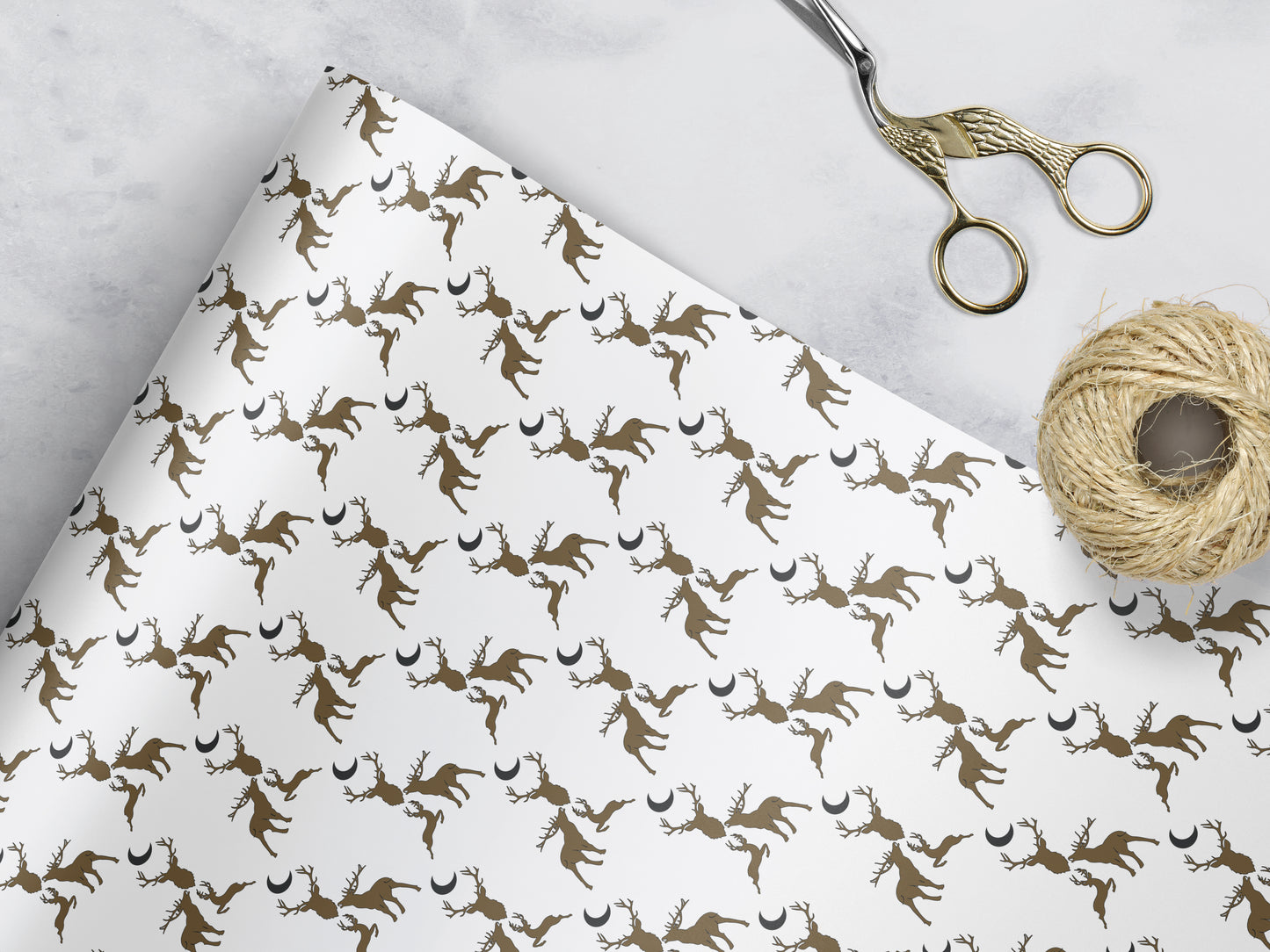 white Wrapping paper with 3 brown stags and a dark grey moon 